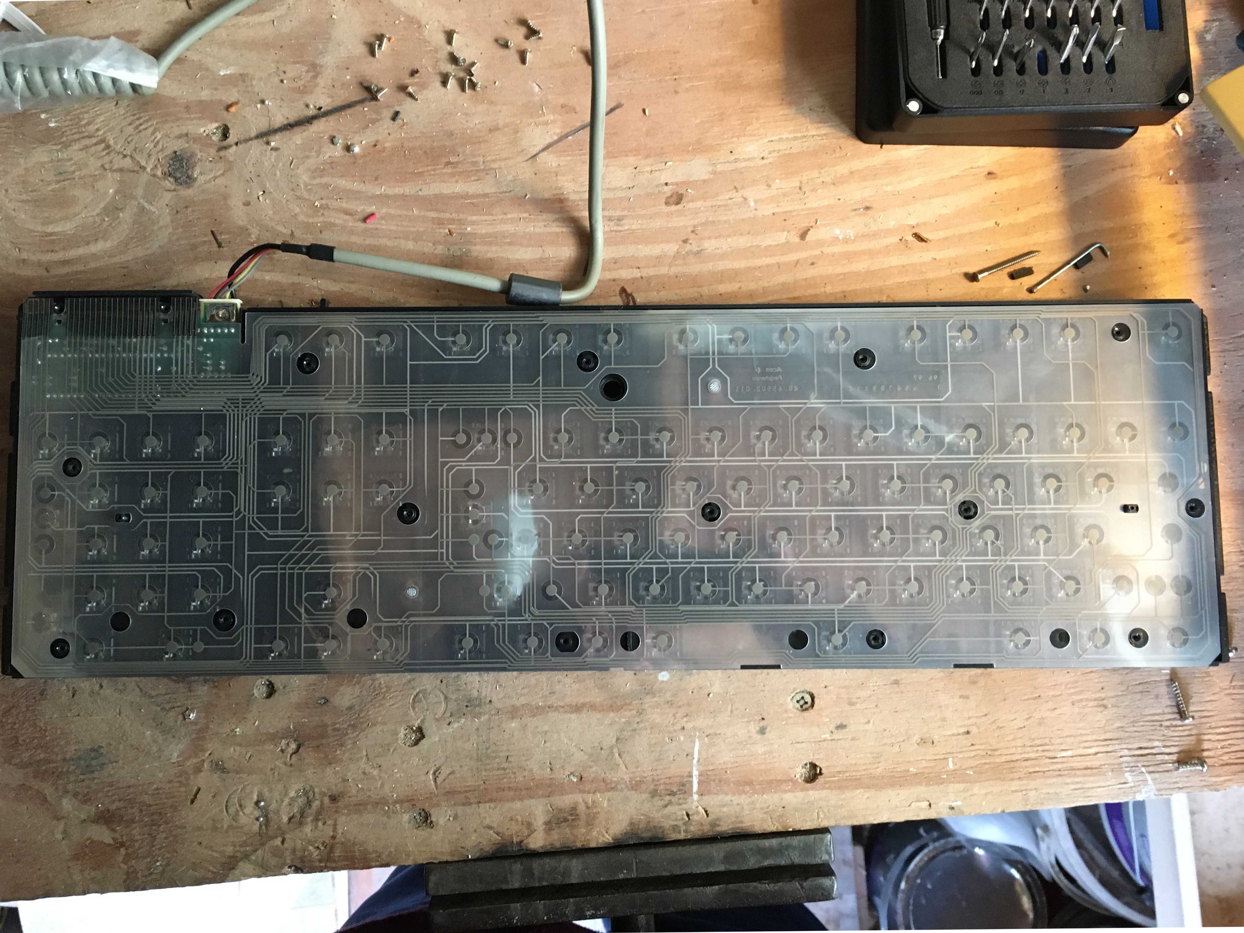 Photo of bottom side of the keyboard with the metal sheet removed, showing membrane layer.
