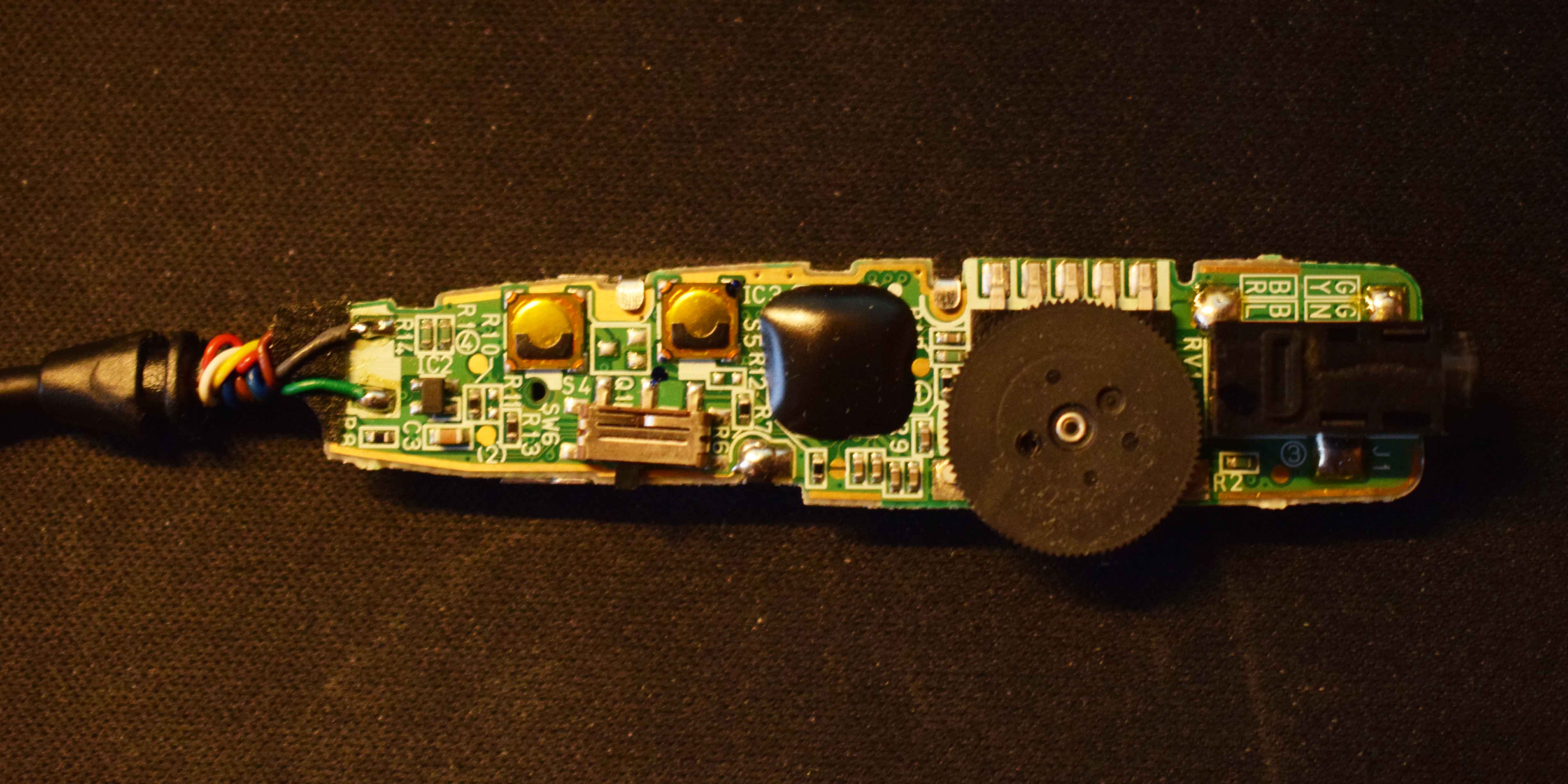 Remote control with entire housing removed, showing rear side of PCB.