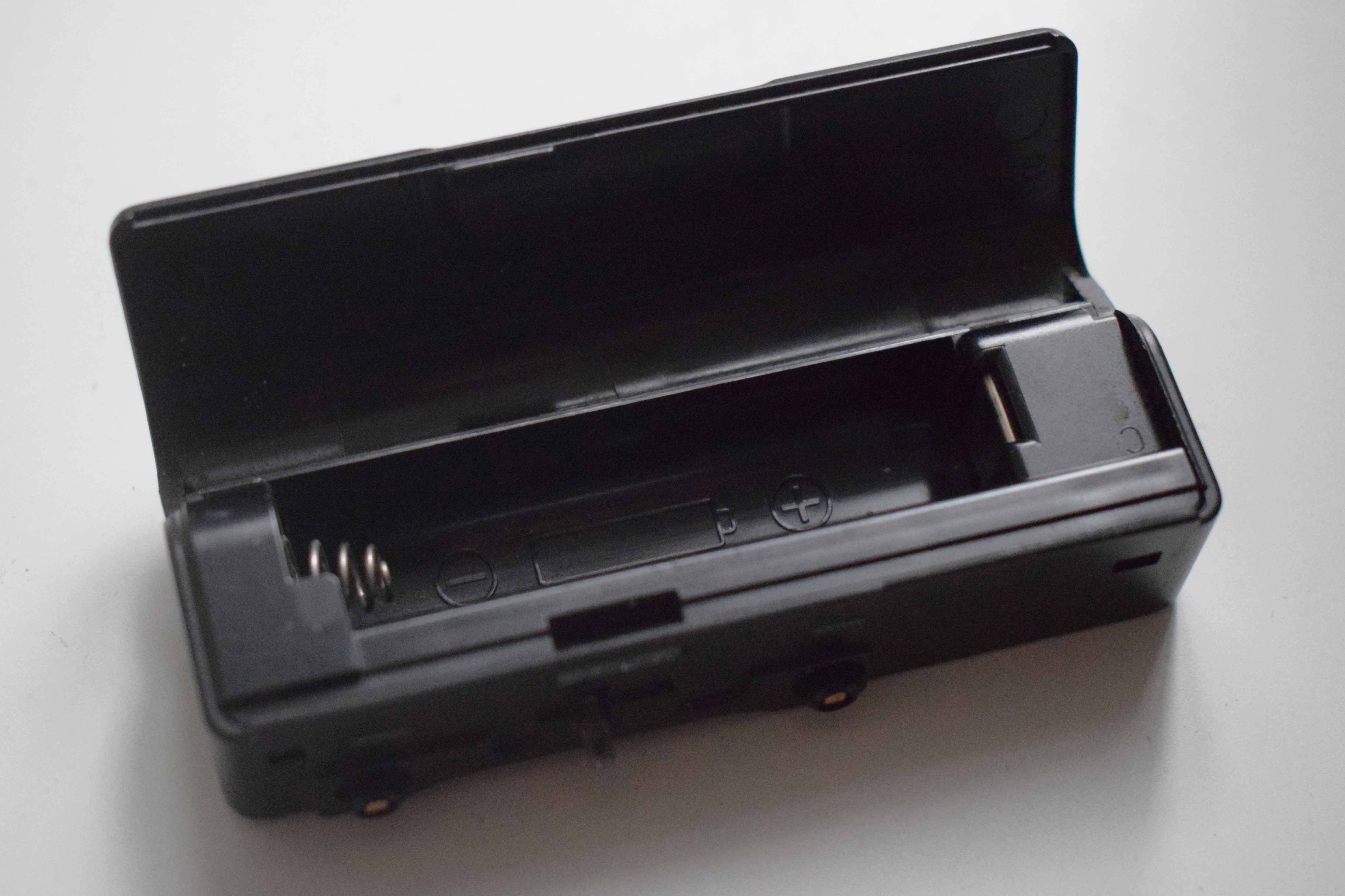 Plastic AA battery holder, opened.