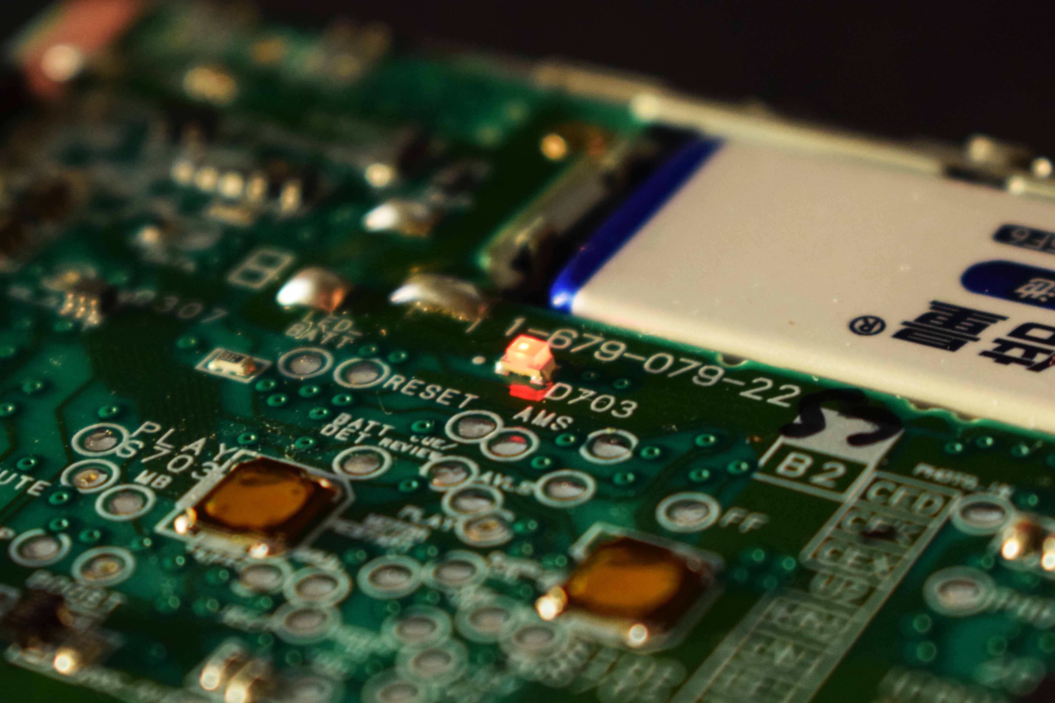 PCB view focusing on the LED indicator that emits through part of the button membrane.