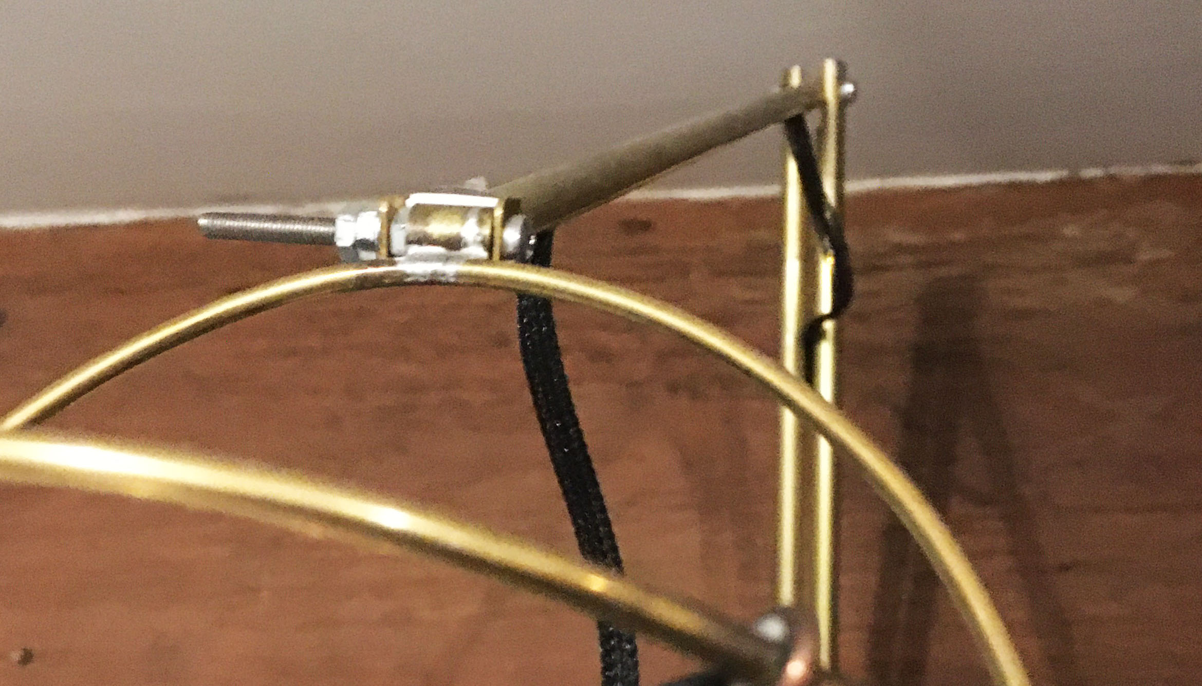 Brass arm holding capsule assembly