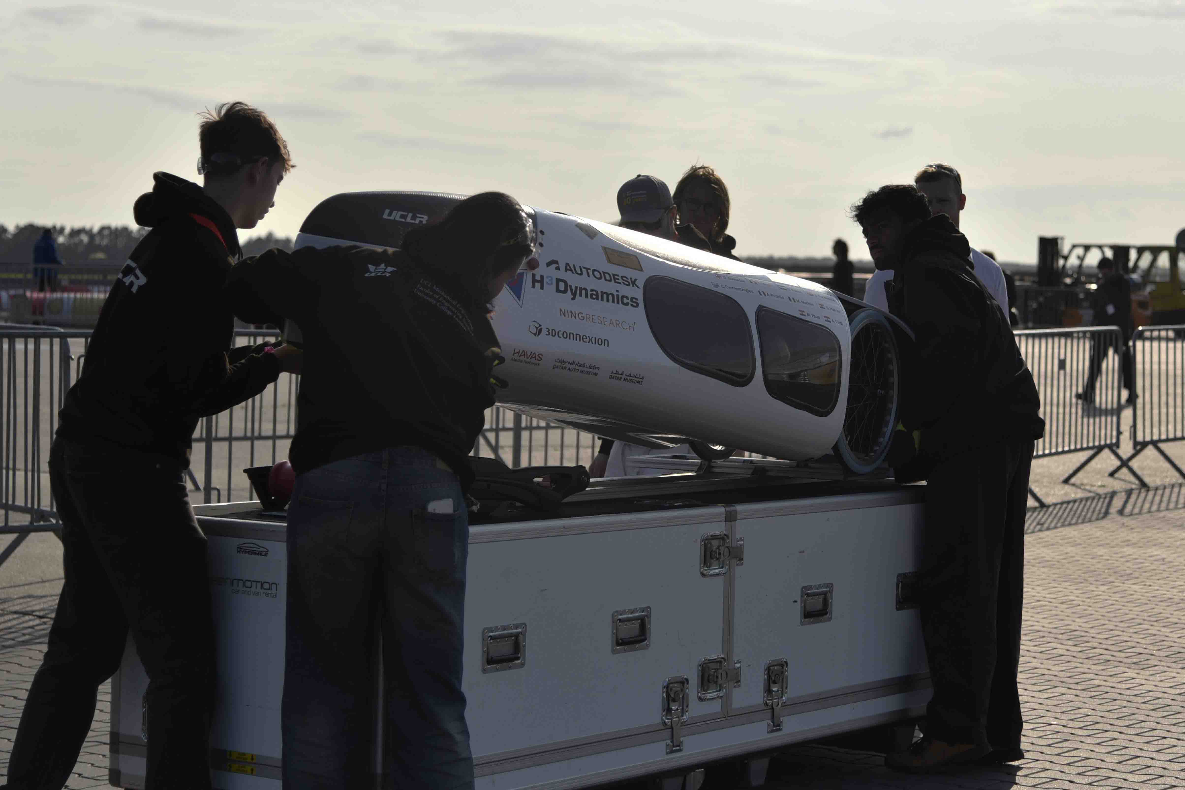 Photo of 2025 team handling hydrogen prototype vehicle.