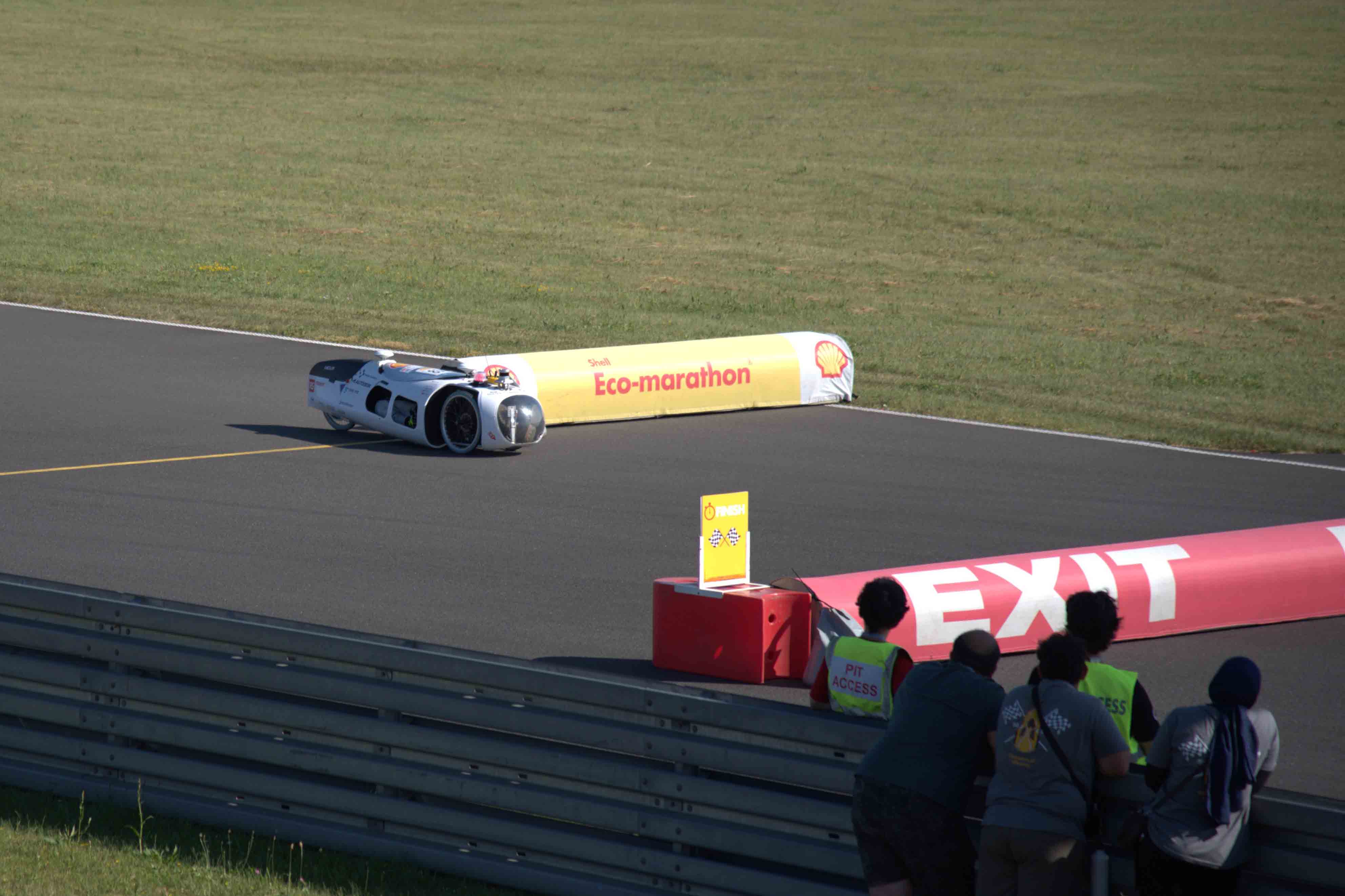 Photo of autonomous vehicle passing the finish line on the winning lap of the Autonomous Driving Competition.