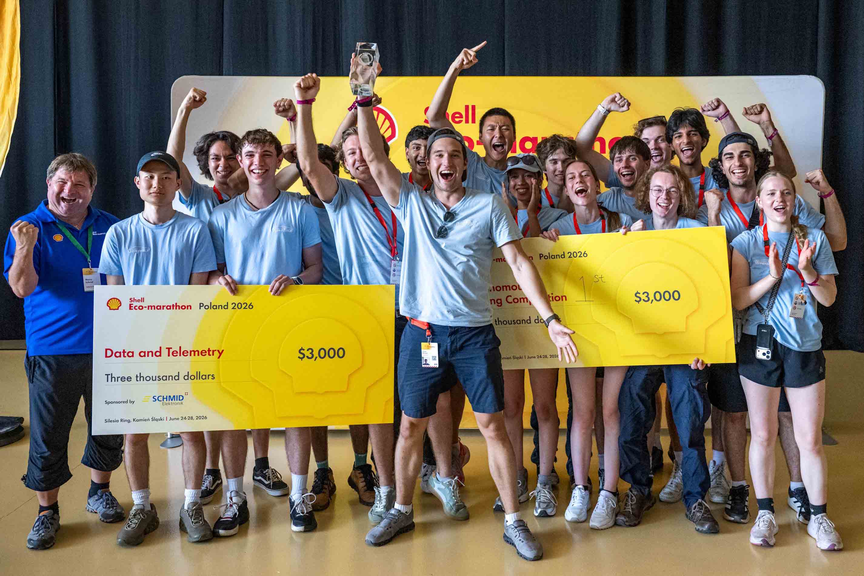 Photo of 2026 team celebrating with comedy cheque for 1st in Data and Telemetry Award and 1st Autonomous Driving Competition.