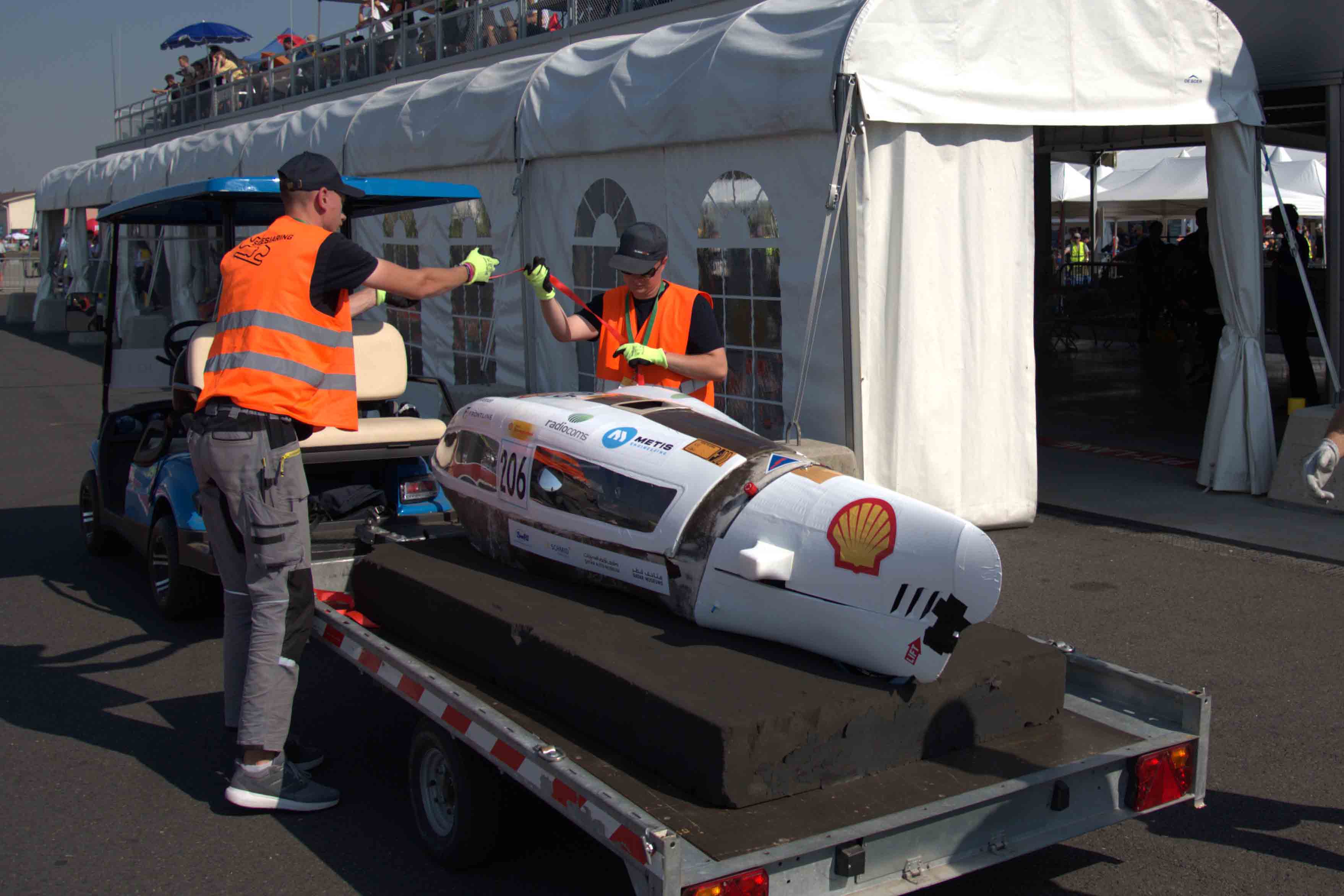 Photo of 2026 hydrogen prototype vehicle on the back of a golf buggy being towed back to the pits.